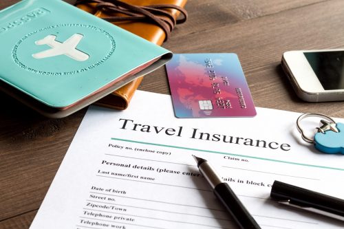 Concept,Booking,Travel,Insurance,On,Wooden,Background