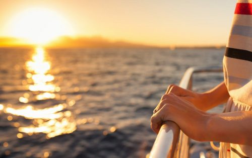 Closeup,Of,Female,Hands,On,A,Cruise,Ship,During,Sunset.